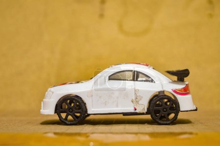 a small white plastic toy car