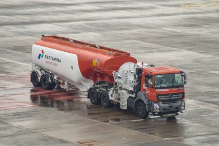 Photo for Pertamina's Mercedes tank truck transporting aviation fuel at Juanda International Airport, Surabaya, Indonesia, 6 January 2024 - Royalty Free Image