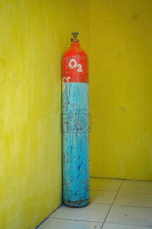 an oxygen cylinder isolated on yellow wall. Perfect for medical content.