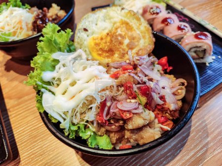 a portion of sambal matah rice bowl with salad vegetables and eggs