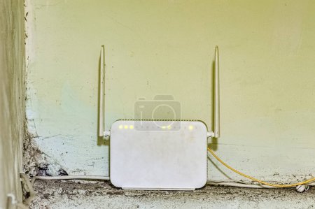 a white wifi router with two antennas