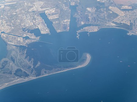 Photo for Aerial view of the cargo port harbor of Port-Saint-Louis-du-Rhone in France, near Marseilles, as seen from a passenger airplane, docks, naval maritime shipping - Royalty Free Image