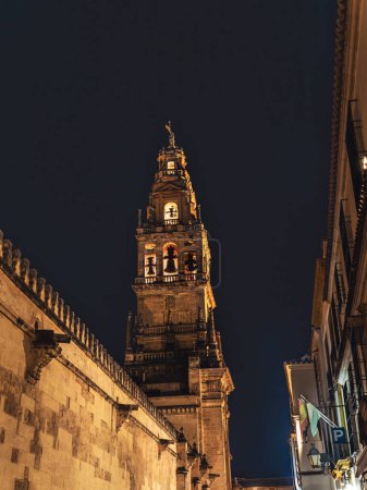 Iconic Tower and Bell Tower of the Mezquita-Catedral, mosque cathedral in Cordoba during summer night, Andalusia, Spain