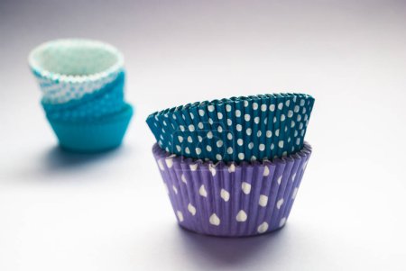 Colorful cupcake liners, polka dot, stacked, grey background