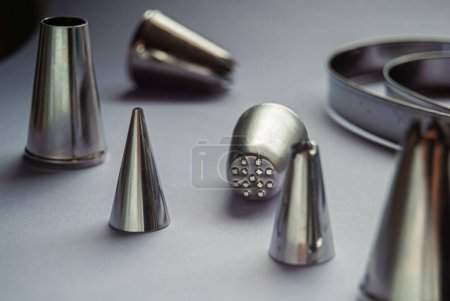 Photo for Baking tools, variety of piping tips on a grey background - Royalty Free Image
