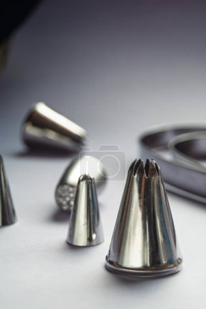 Photo for Baking tools, variety of piping tips on a grey background - Royalty Free Image
