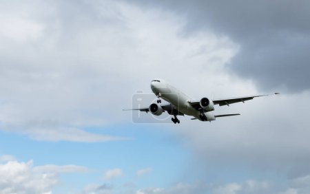 Photo for Airplane with landing gear extended in the sky. Travel concept with copy space - Royalty Free Image