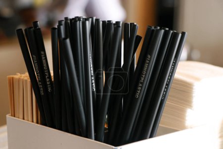 Photo for Natural eco-friendly disposable paper straws in coffee shop on wooden background with copy space. Save the earth, waste reduction concept. - Royalty Free Image