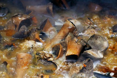 Photo for Authentic veal or beef bone stock boiling in a hot large pot - Royalty Free Image
