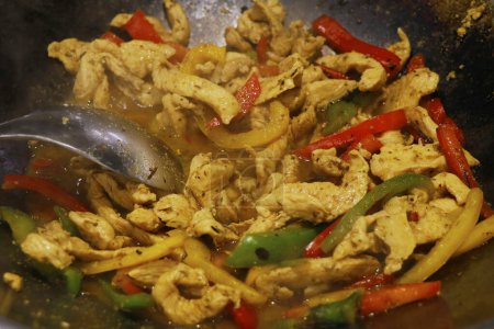Photo for Mexican food, chicken fajitas preparing on a hot pan - Royalty Free Image