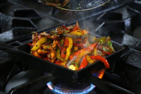 Photo for Mexican fajitas on sizzling plate - Royalty Free Image