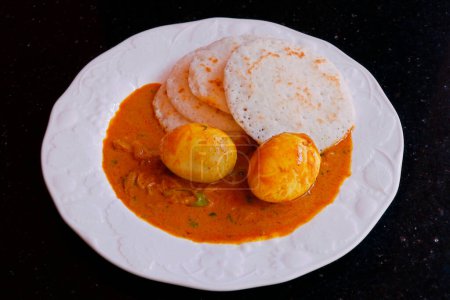 Photo for Traditional kerala style breakfast rice cake known as appam with egg curry - Royalty Free Image