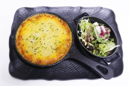 Photo for Traditional english cottage pie with mixed leaves salad - Royalty Free Image