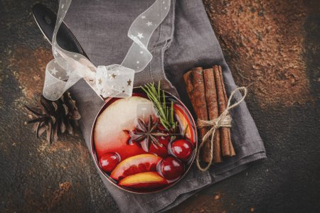 Photo for Hot mulled wine with fruits and spices. Autumn or winter warm drink - Royalty Free Image