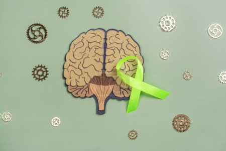 Téléchargez les photos : Journée mondiale de la santé mentale, 10 octobre. Cerveau avec engrenages et ruban vert, symbole de la santé mentale - en image libre de droit