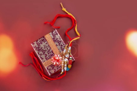 Photo for Raksha Bandhan background. Gift box and rakhi bracelet. Traditional Indian Holiday Festival Raksha Bandhan - Royalty Free Image