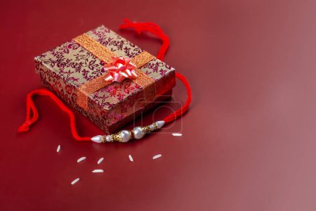 Photo for Raksha Bandhan background. Gift box and rakhi bracelet. Traditional Indian Holiday Festival - Royalty Free Image