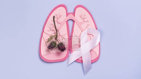 Photo for Branch of thistle as a symbol of sick lungs, white ribbon. World Tuberculosis Day, Pneumonia day or World Lung Day concept. Organ donation day. No tobacco or smoking kills background - Royalty Free Image