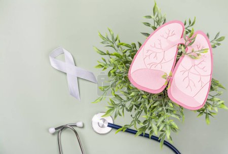 Photo for Healthy pink lungs over green foliage, white ribbon and stethoscope. World Tuberculosis Day, Pneumonia day or World Lung Day concept. Organ donation day. No tobacco or smoking kills background - Royalty Free Image