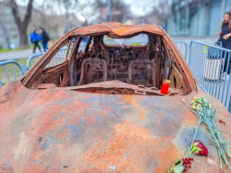 Exhibition in Prague, Czech, burned-out civilian car. War in Ukraine. Russian invasion of Ukraine. War crimes. High quality photo