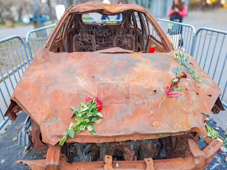 Exhibition in Prague, Czech, burned-out civilian car. War in Ukraine. Russian invasion of Ukraine. War crimes. High quality photo