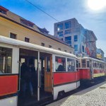 Prague-, Czech- 18 March 2024: Passengers enjoy a ride in a oldest tram in Prague. Historic classic red tram of Prague built partially of wood. High quality photo
