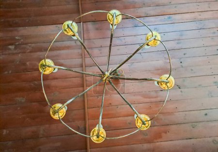 View of an antique chandelier from below. Metal wrought iron antique ceiling light. High quality photo