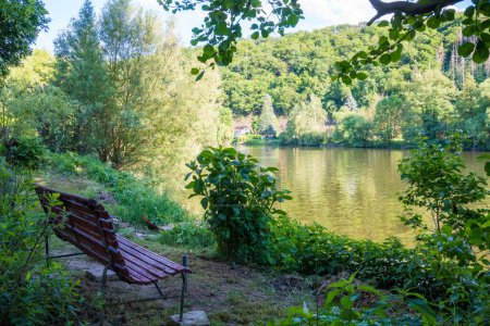 Beautiful views near the Berunka River Bench for rest by the river in spring, forest and mountains. Near Karlstejn. Czech. High quality photo