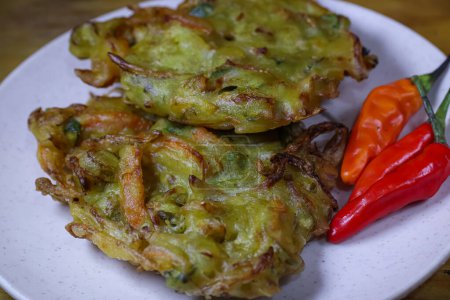 "bakwan" on a plate with chili, a traditional Indonesian snack made with flour and vegetables. 