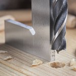 drill bit with steel triangle ruler make sink in hole for screw in wooden oak plank