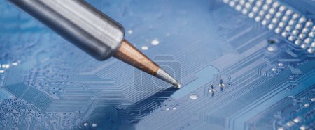 Photo for Soldering electronic components onto the PCB. Electronics repair and digital technology. - Royalty Free Image