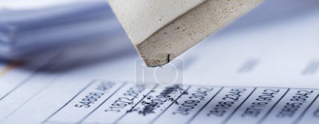 Photo for Fix with eraser financial data in document. Concept of banking, financial report and financial audit. - Royalty Free Image