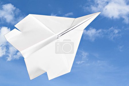 Photo for White paper plane isolated on blue background - Royalty Free Image
