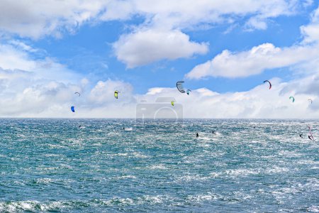 People practicing kitesurfing on the beach of Los Caos de Meja, next to the Trafalgar Lighthouse, Barbate, Cadiz