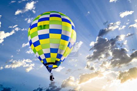 Photo for Colorful hot air balloon flying over blue sky with white clouds - Royalty Free Image