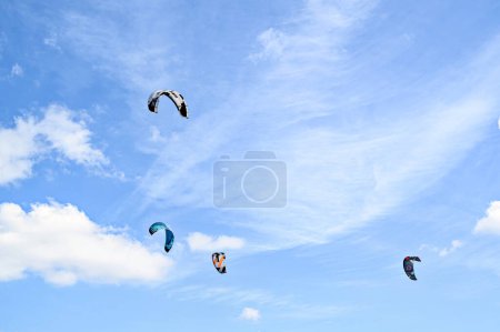 Photo for Los Canos de Meca, Barbate, Cdiz; August 19, 2022: athletes practicing kitesurfing in front of the beach of the Trafalgar Lighthouse - Royalty Free Image