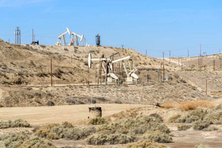 Photo for Pumpjacks in a oil field on a clear autumn day. Bakersfield, CA, USA - Royalty Free Image