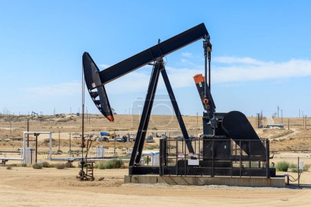 Photo for Close up of a pumpjack in a oil field in California on a sunny autumn day. Bakersfield, CA, USA - Royalty Free Image