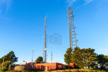 Téléchargez les photos : Antennes de télécommunication au sommet d'une colline sous un ciel dégagé au coucher du soleil. San Francisco, CA, États-Unis. - en image libre de droit