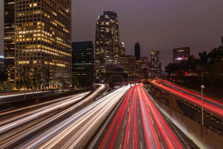 Téléchargez les photos : Los Angeles downtown skyline with rush hour traffic streaming along a freeway. California, USA. - en image libre de droit
