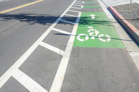 Photo for Bicycle lane marked in green along a road in a business park on a sunny day. Mountain View, CA, USA. - Royalty Free Image