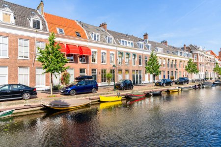 Photo for Brick row houses along a canal on a sunny summer day. The Hague, Netherlands. - Royalty Free Image