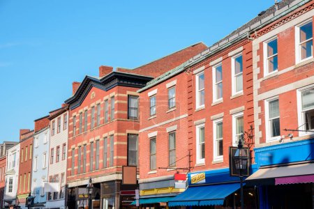 Photo for Row of tradtional American brick buildings with shops on the ground floor in a old downtown district on a clear autumn day. Portsmouth, New Hampshire. - Royalty Free Image