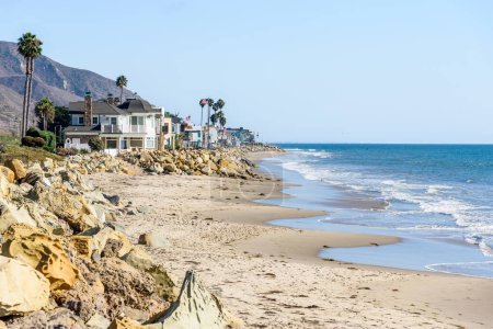 Photo for Row of modern oceanfront houses on a sandy beach along the coast of California on a sunny autumn day - Royalty Free Image