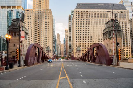 Photo for Street movable bridge spanning Chicago river at sunset in spring. Illinois, USA. - Royalty Free Image