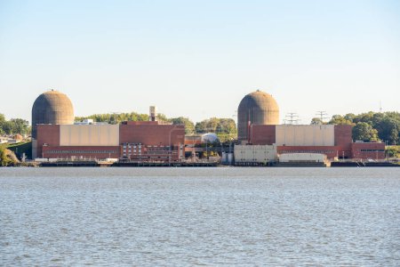 Photo for Nuclear power plant on the bak of a river on a sunny autumn day. Hudson river valley, NY, USA. - Royalty Free Image