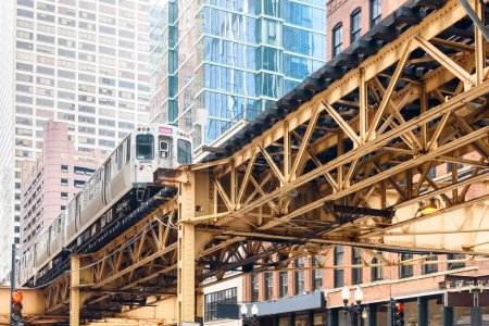 Photo for Train on elevated rail tracks in downtown Chicago on a spring day. Chicago Loop,  Illinois, USA. - Royalty Free Image