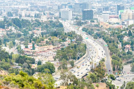 Aerial view of a busy freeway in Los Angels on a misty autumn morning. CA, United States.