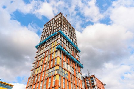 Photo for Low angle view of a high rise residential tower under construction on a sunny summer day. Manchester, England, UK. - Royalty Free Image
