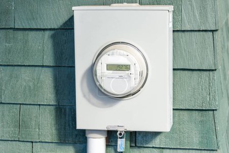 Close up of a smart electricity meter on a wooden wall